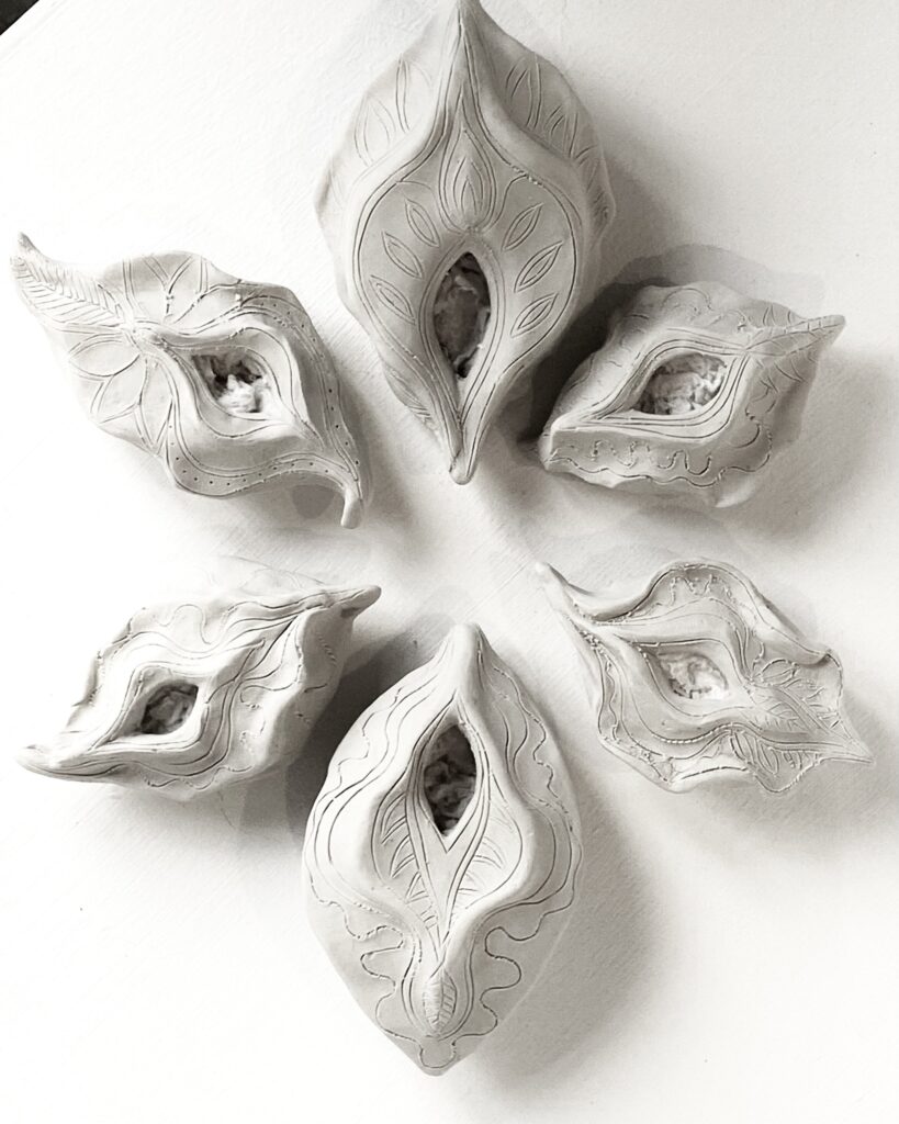 A circle of Yoni Lamps made from white clay.