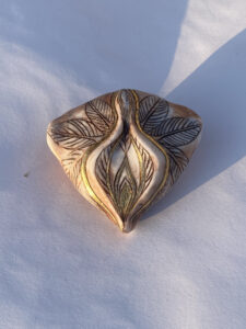 A golden leaf pendant.