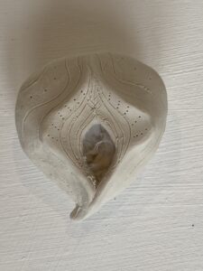 A white Yoni Lamp shell on a white surface.