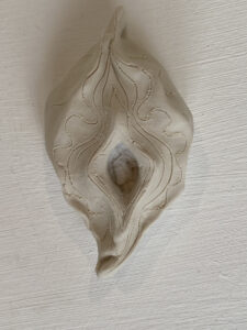 A Yoni Lamp, made of white ceramic, featuring a unique design.