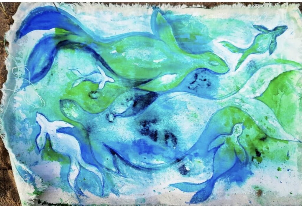 A watercolor painting of a group of blue and green fish.