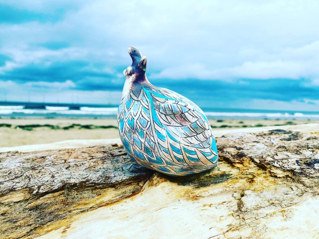 A blue and white bird sitting on a piece of wood.