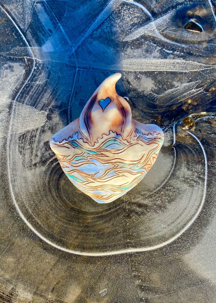 A piece of glass sitting on top of a piece of ice.