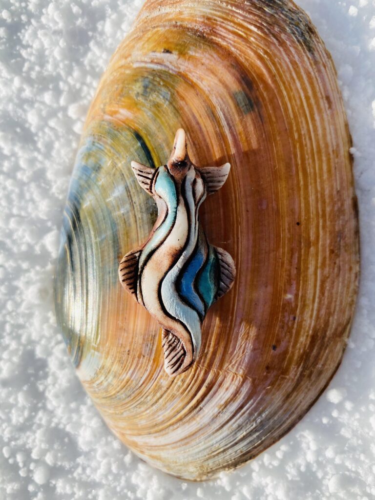 A sea creature is sitting on top of a shell.