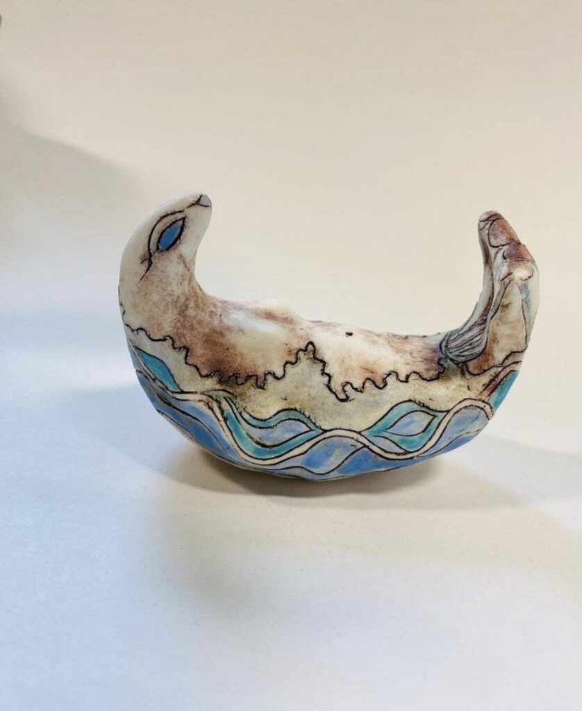 A ceramic boat with a blue and white design.