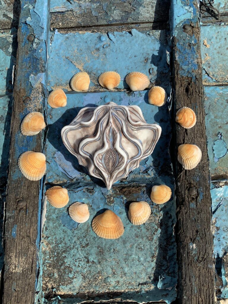 A blue boat with shells on it.