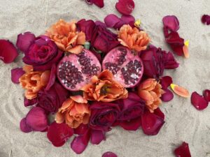 A Yoni Mandala featuring a bouquet of pomegranate and orange flowers.