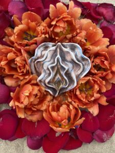 A Yoni Mandala is encased by a metal framework.